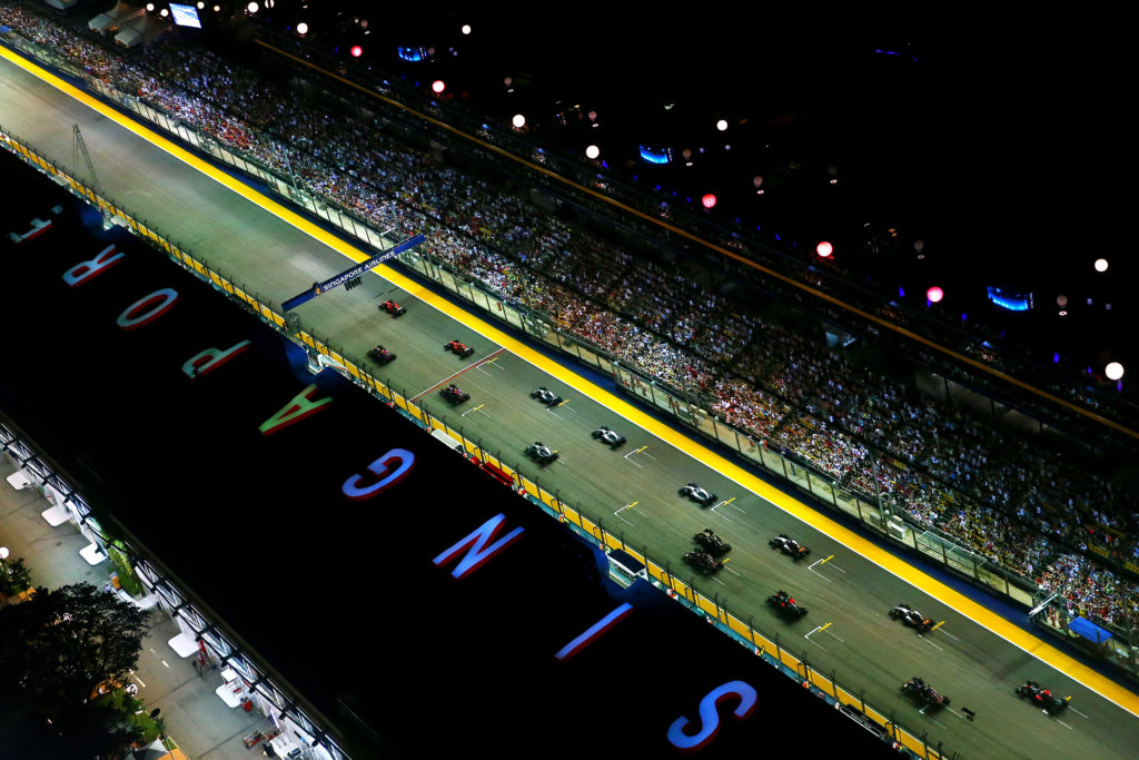 SINGAPORE - SEPTEMBER 20: Sebastian Vettel of Germany and Ferrari pulls away from the start ahead of Daniel Ricciardo of Australia and Infiniti Red Bull Racing, Kimi Raikkonen of Finland and Ferrari, Daniil Kvyat of Russia and Infiniti Red Bull Racing and Lewis Hamilton of Great Britain and Mercedes GP during the Formula One Grand Prix of Singapore at Marina Bay Street Circuit on September 20, 2015 in Singapore. (Photo by Dan Istitene/Getty Images)