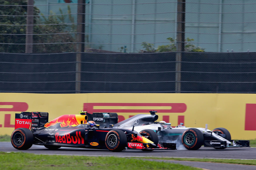 SUZUKA, JAPAN - OCTOBER 09: Lewis Hamilton of Great Britain driving the (44) Mercedes AMG Petronas F1 Team Mercedes F1 WO7 Mercedes PU106C Hybrid turbo locks a wheel under braking as he tries to overtake Max Verstappen of the Netherlands driving the (33) Red Bull Racing Red Bull-TAG Heuer RB12 TAG Heuer on track during the Formula One Grand Prix of Japan at Suzuka Circuit on October 9, 2016 in Suzuka. (Photo by Charles Coates/Getty Images)